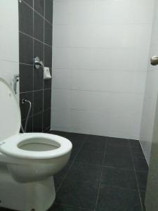 a bathroom with a toilet and a tiled floor at NAUFAL MUSLIM'S HOMESTAY in Cameron Highlands