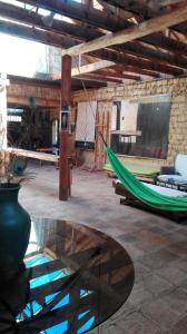 a room with a green hammock and a table at Chalet Casa de Teja in Tinjacá