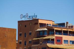 a building with a sign on the top of it at Dar Amoudou in Ouarzazate