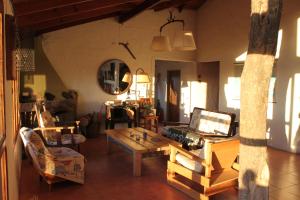 a living room filled with furniture and a table at Bla Lodge in El Calafate