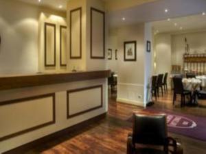 a living room with a bar and a dining room at Hotel Antin St Georges in Paris
