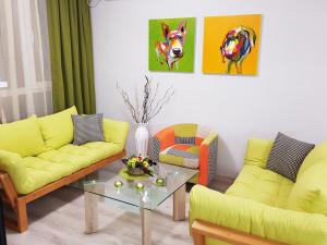 sala de estar con sofás amarillos y mesa en Best Guest Apartments en Plovdiv