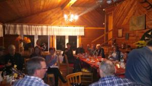 a group of people sitting at a table in a restaurant at Dom "Honorat", Kamianna 70, 33-336 in Kamianna