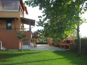 a house with a green lawn in front of it at Hawaii in Nea Michaniona