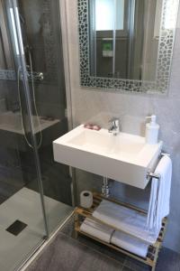 a bathroom with a sink and a shower at Hotel Costa Azahar in Grao de Castellón