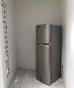 a stainless steel refrigerator in a corner of a room at Casa Colonial Centro in Mérida