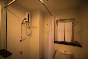 La salle de bains est pourvue d'une douche et de toilettes. dans l'établissement Napatra Hotel, à Chiang Mai
