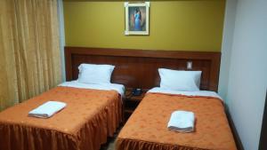 Postel nebo postele na pokoji v ubytování Sumaq Hotel Tacna
