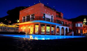 a building with a pool in front of it at night at Le Divine La Terrazza in Levanto