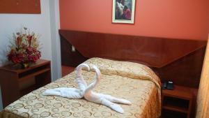 Postel nebo postele na pokoji v ubytování Sumaq Hotel Tacna
