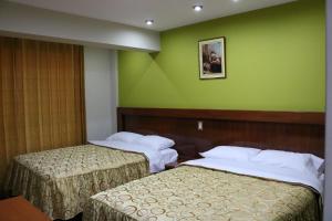 Postel nebo postele na pokoji v ubytování Sumaq Hotel Tacna