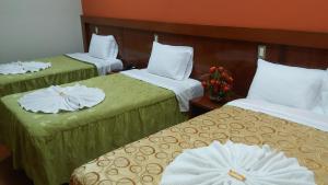 Postel nebo postele na pokoji v ubytování Sumaq Hotel Tacna