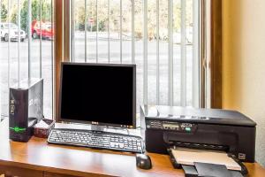 a computer desk with a monitor and keyboard at Quality Inn Kodiak in Kodiak