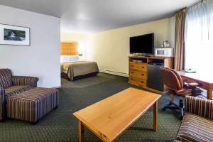 a hotel room with a bed and a living room at Quality Inn Kodiak in Kodiak