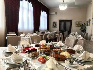a dining room with a table with food on it at Golden Inn Hotel in Majdanpek