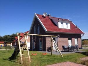 a house with a playground in front of it at Ferienhaus Strandgut in Petersfeld