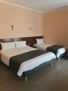 Voodi või voodid majutusasutuse Hôtel Vesuvio toas