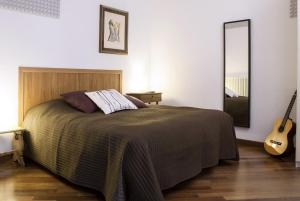 מיטה או מיטות בחדר ב-Alloggio La Volta