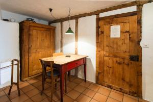 a small table in a room with wooden doors at Ferienhaus Tinizong in Tinzen