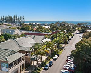 a city street filled with lots of trees and houses at Byron Bayside Central Studio Apartments in Byron Bay