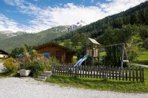 a playground with a slide in front of a house at Haus Fernblick in Neustift im Stubaital