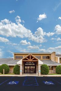 a building with a parking lot in front of it at AmericInn by Wyndham Dickinson in Dickinson