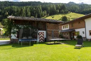 a house with a table and chairs in the yard at Haus Fernblick in Neustift im Stubaital