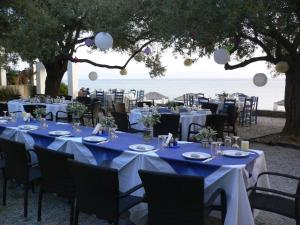 a table set up for a wedding with the ocean in the background at Megalos Mourtias in Alonnisos