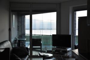 a living room with a television and a large window at Am Neuen Hafen in Bremerhaven