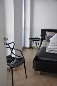 a room with a bed and a chair and a table at Am Neuen Hafen in Bremerhaven +17 photos
