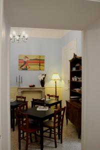 a dining room with a table and chairs and a room with a fireplace at Al 68 Di Piazza Cavour in Naples