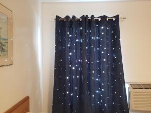 a curtain with stars on it in a room at Covered Bridge Inn & Suites in Sussex
