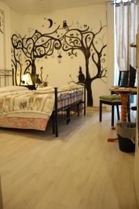 a bedroom with a bed and trees on the wall at Al 68 Di Piazza Cavour in Naples