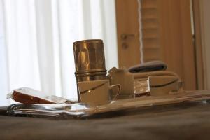 a reflection of a table with cups and a mirror at Al 68 Di Piazza Cavour in Naples +97 photos