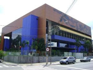 a blue building with cars parked in front of it at Namorata Expo Inn in São Paulo