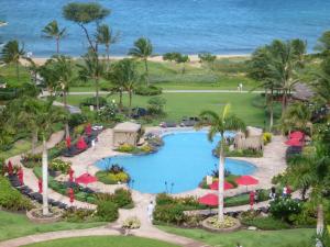 an aerial view of a resort with a pool and the ocean at Konea 244 at Honua Kai in Lahaina
