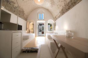 a kitchen with a table and a living room at Tritiani Traditional Home in Mesaria