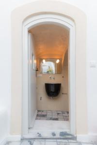 an archway leading to a bathroom with a sink at Tritiani Traditional Home in Mesaria