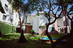 a house with a pool in the yard with trees at Vila Luis Mendes in Ribeira Brava