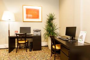 an office with a desk with a computer and chairs at Adabco Boutique Hotel Adelaide in Adelaide