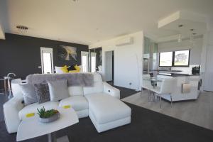 a living room with a white couch and a table at Horizon Deluxe Apartments in Stanley