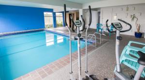 a swimming pool in a gym with blue walls at Absolute Lake View Motel in Taupo
