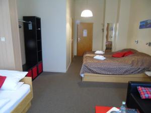a hotel room with two beds and a room with at Landhaus Irmgard in Braunlage