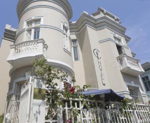 a large white house with a white fence at Casa Falleri Boutique Hotel in Lima