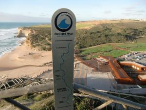 a sign on a hill next to a beach at The Surf Studio - Ericeira in Ericeira