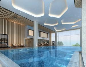 a large swimming pool in a building with a ceiling at Xiamen Airlines Lakeside Hotel in Xiamen