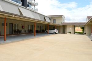 a car parked in front of a building at Mid City Motor Inn in Gladstone