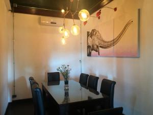 a dining room with a table and a picture of an elephant at Seasons Riverside Hotel in Vientiane +8 photos