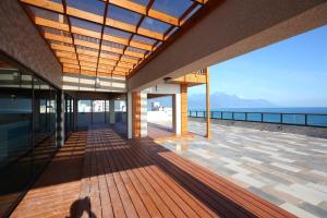 a building with a deck with the ocean in the background at Seven Stars Sunrise,Seven Stars DEAR in Dahan