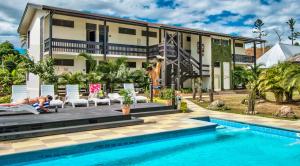 a woman laying on a chair in front of a house at Tanoa Rakiraki Hotel in Rakiraki